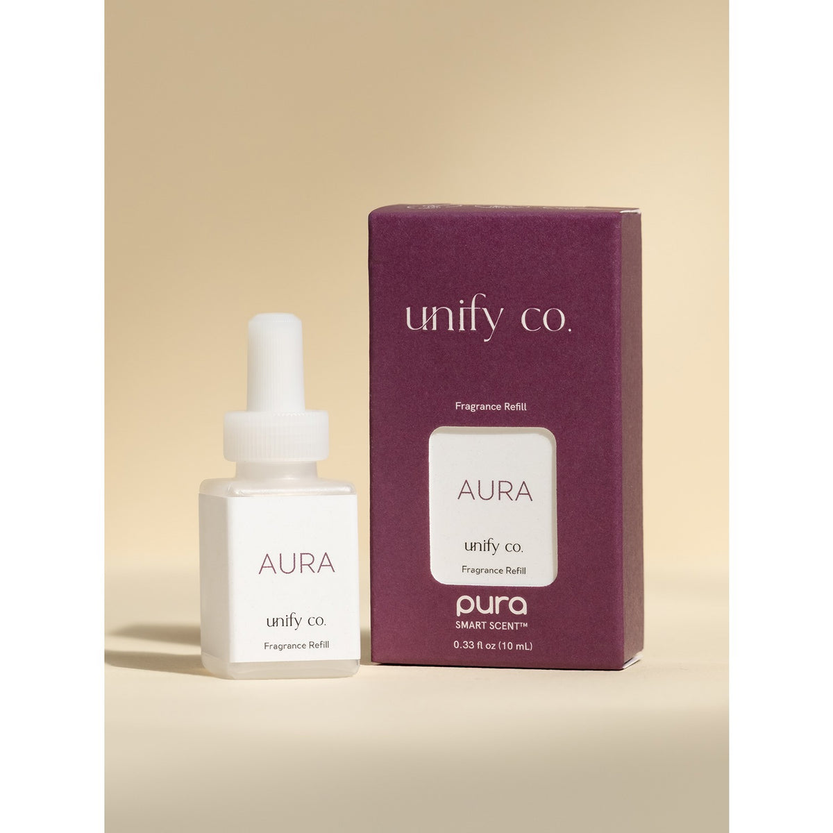 Aura fragrance bottle and packaging by unify co on a beige background