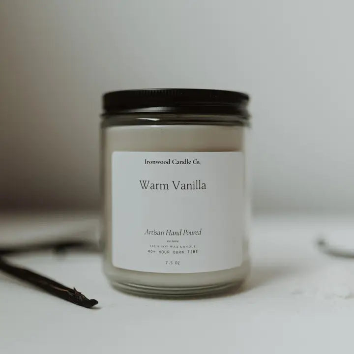 Candle labeled 'Warm Vanilla' by Ironwood Candle Co. on a neutral background