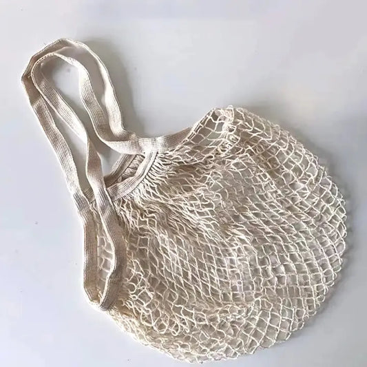 Beige mesh shopping bag with handles on a white background