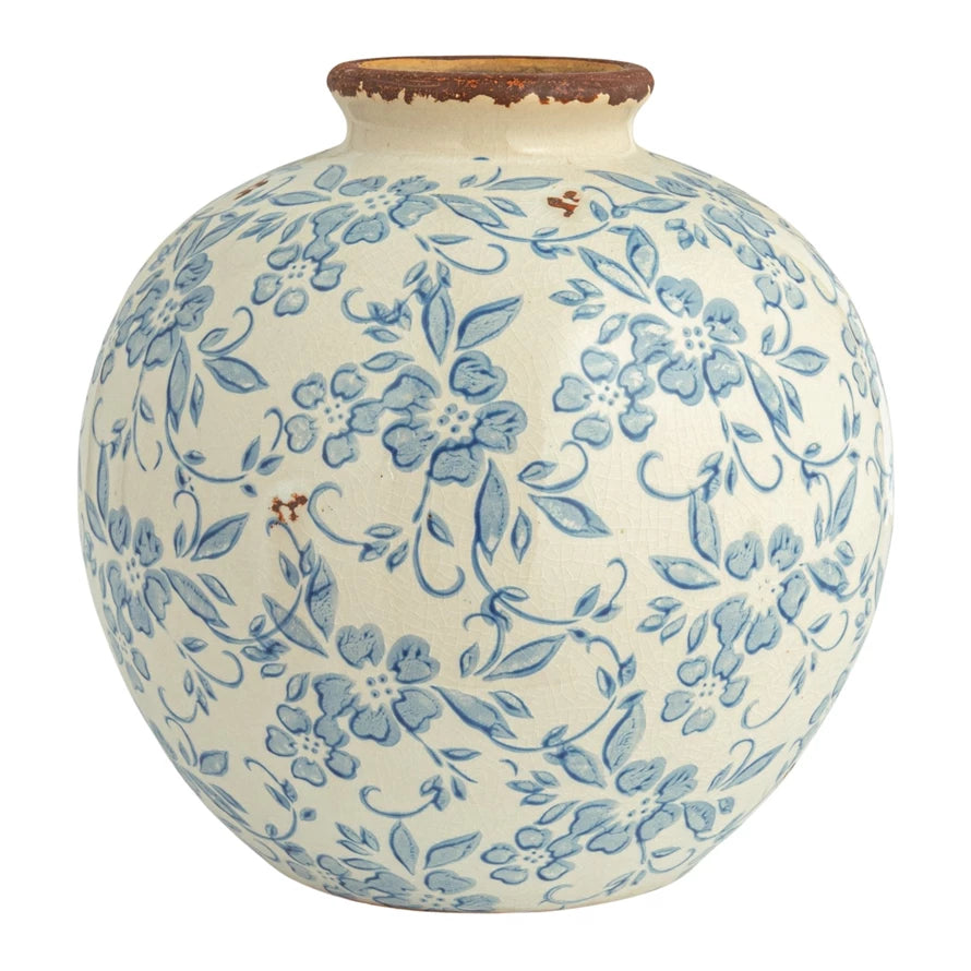 Ceramic vase with blue floral pattern on a white background