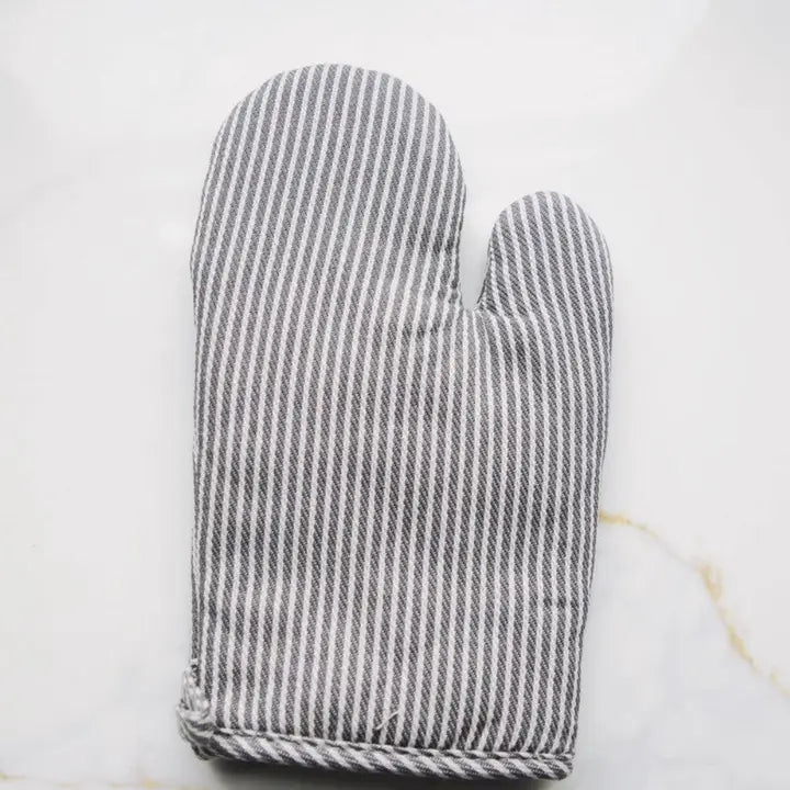 Gray and white striped oven mitt on a light marble background