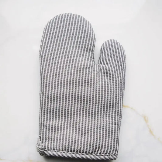 Gray and white striped oven mitt on a light marble background
