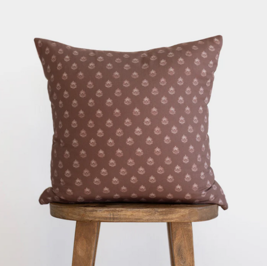 Plum Block Print Pillow Cover with a subtle pattern on a wooden stool against a white background