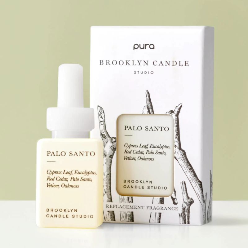 Pura Brooklyn Candle Palo Santo replacement fragrance bottle and packaging on a light green background