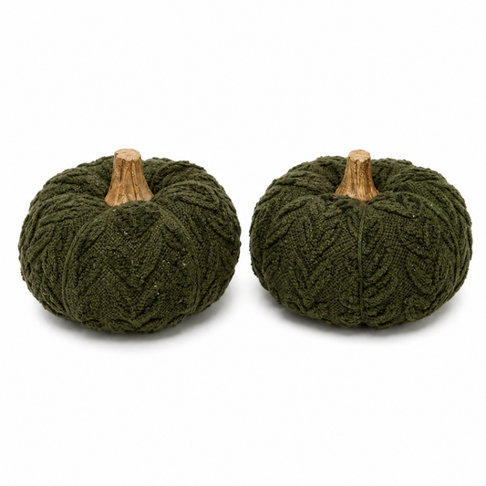 Two small decorative pumpkins made from dark olive green chunky knit fabric, each with a light brown faux-wood stem, shown on a plain white background.