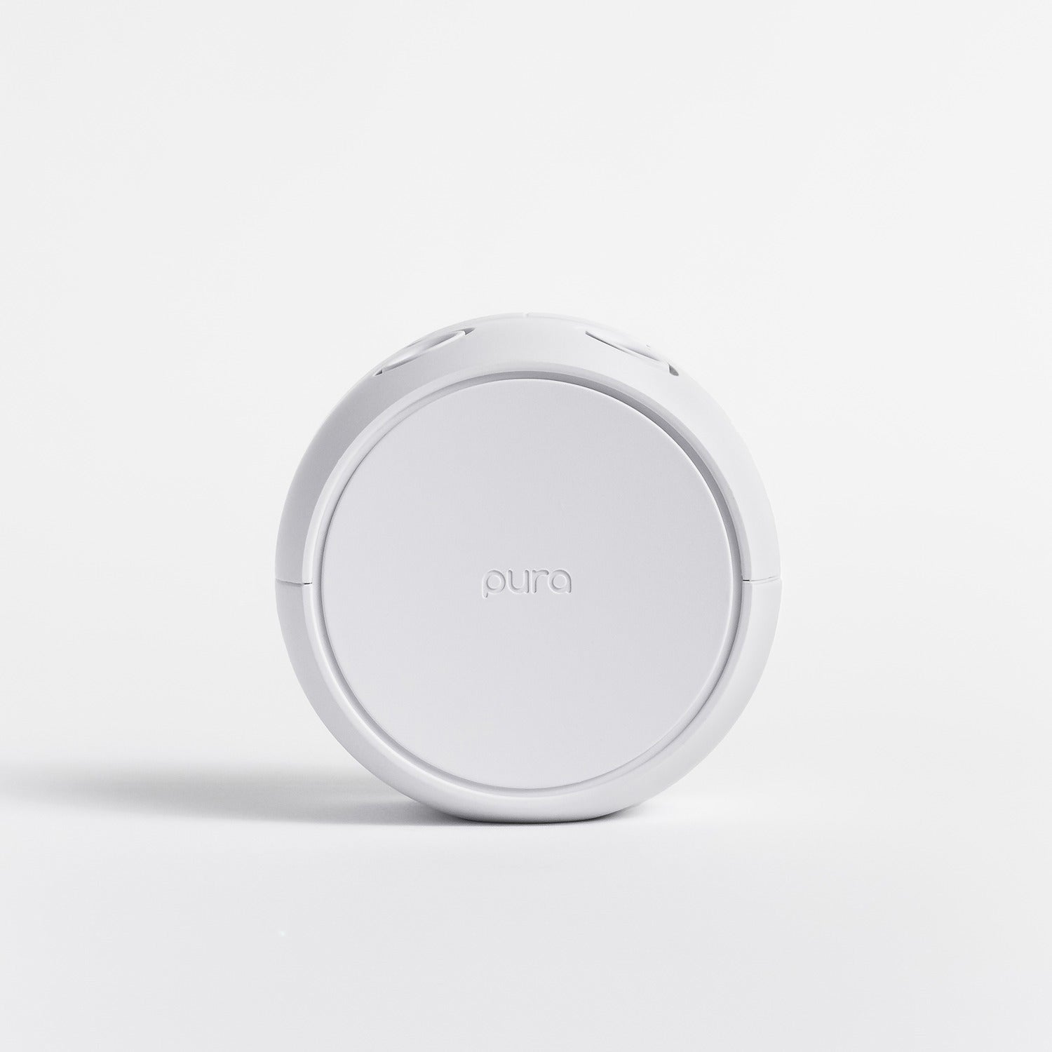 White Pura fragrance device with white background