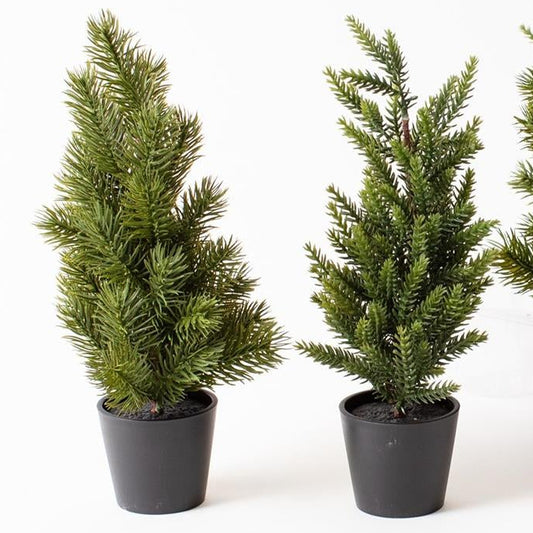 Set of potted artificial trees on a white background