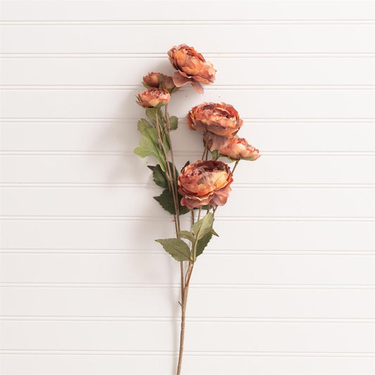 Dried pink flower arrangement on a white wooden surface